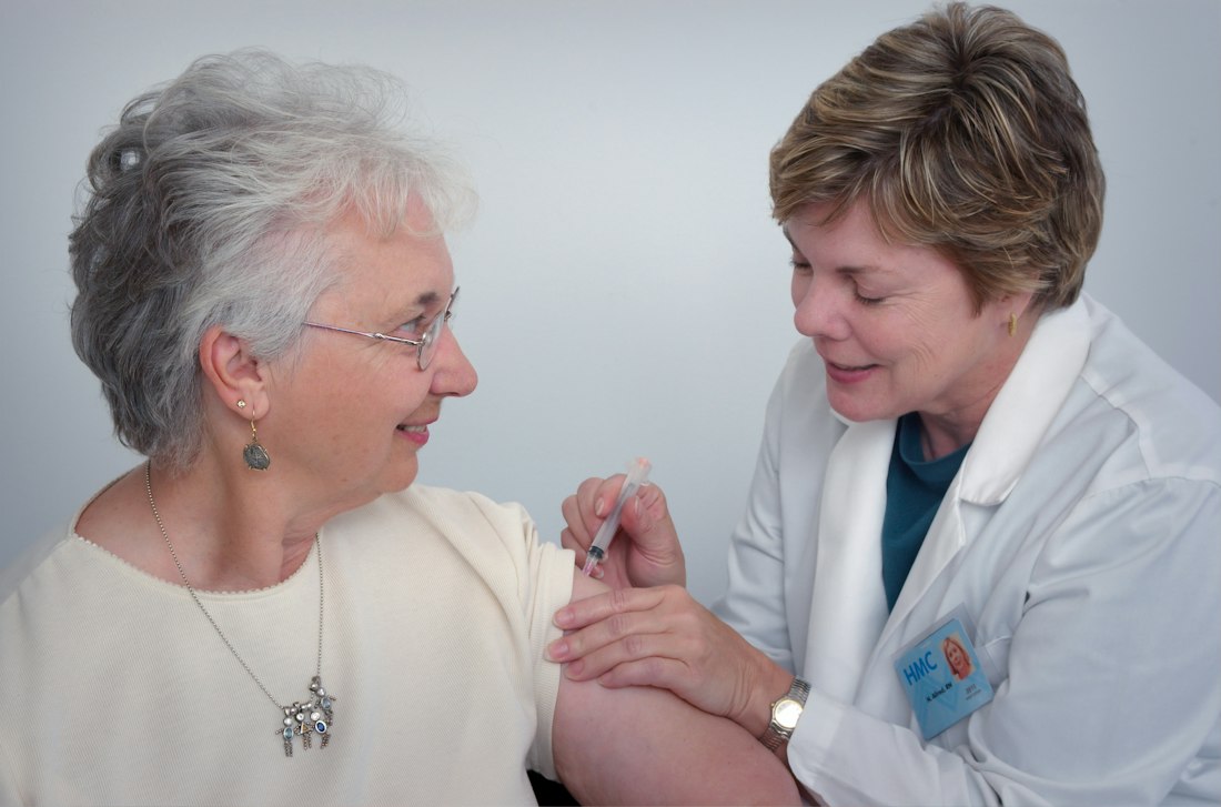 A nurse caring for an elderly woman at home